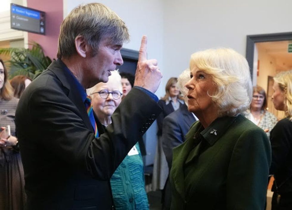 The Queen speaking with author Sir Ian Rankin during the visit to National Library of Scotland