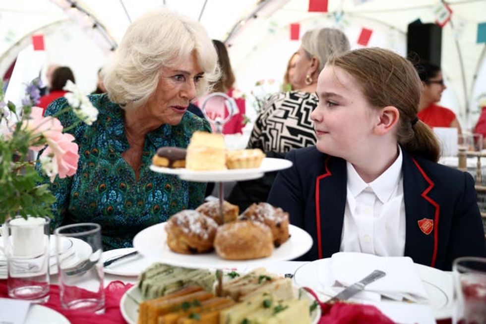 The Queen speaks to a young guest during a Big Lunch at the British Library in London