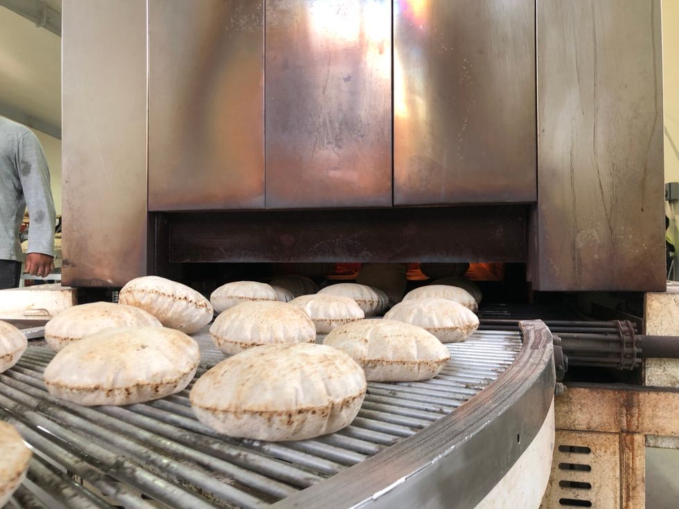 The rotis coming out the oven at the on-site factory