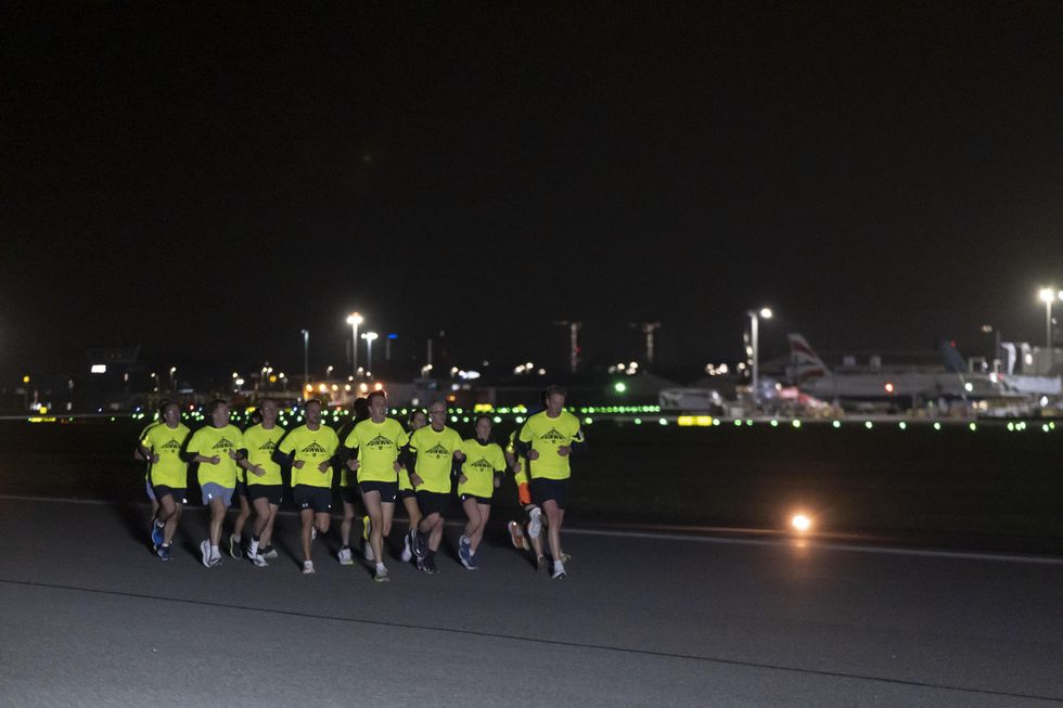 Joggers take off along runway in night-time airport fun run