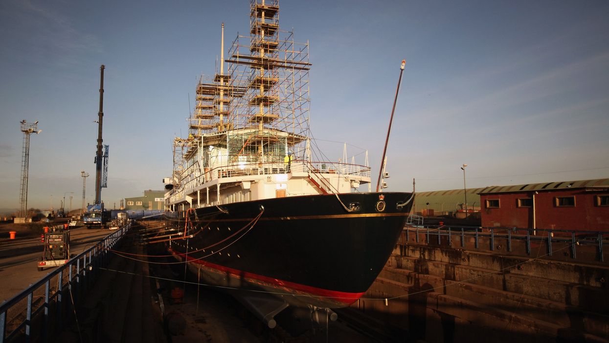 The Royal Yacht Britannia docked at a port for repairs.