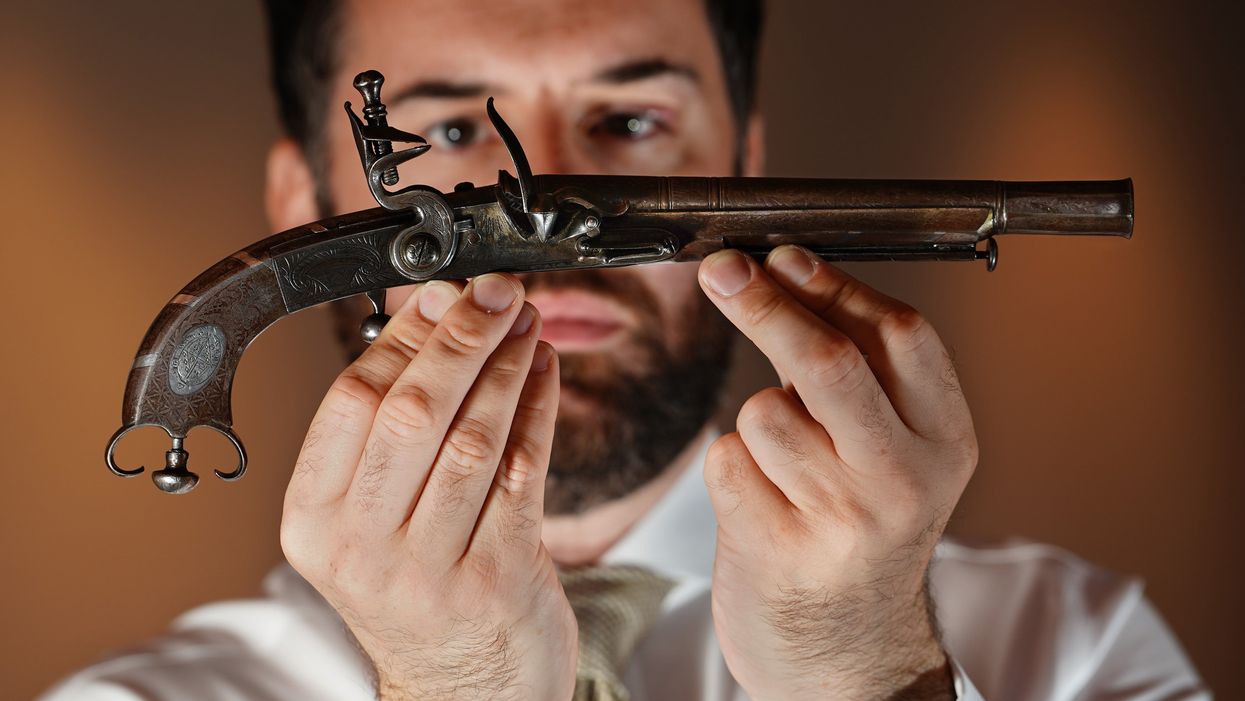The silver pistol was specially made for the author (Stewart Attwood/PA)