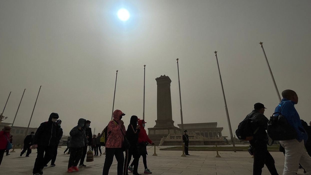 <p>The sky has swapped the colours around thanks to a sandstorm that is ravaging through the capital city</p>