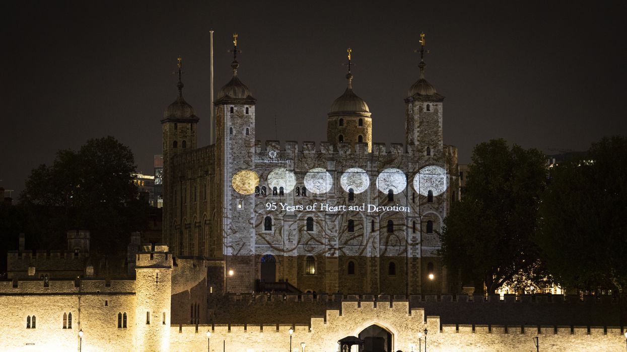 The south wall of the Tower of London bearing projected images of coins from the Queen's reign