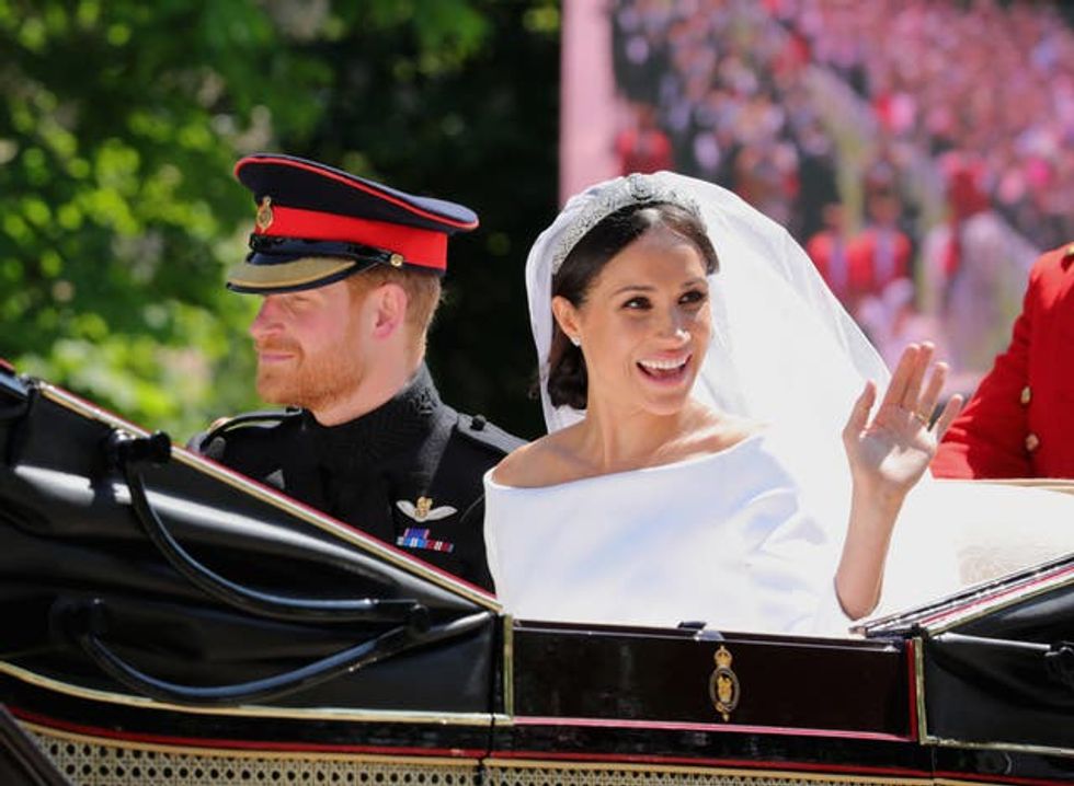 The Sussexes ride in an open-topped carriage through Windsor Castle after their wedding in St George\u2019s Chapel
