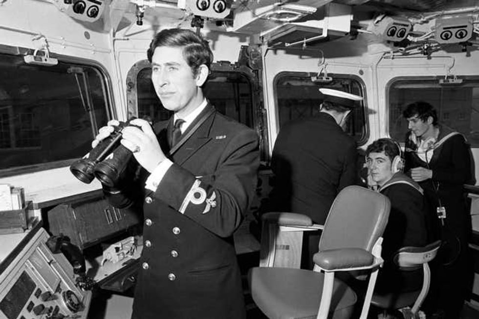 The then-Prince of Wales in Naval uniform holding binoculars while serving as a Sub-Lieutenant on the bridge of the frigate Minerva before routein patrols around the West Indies in 1973