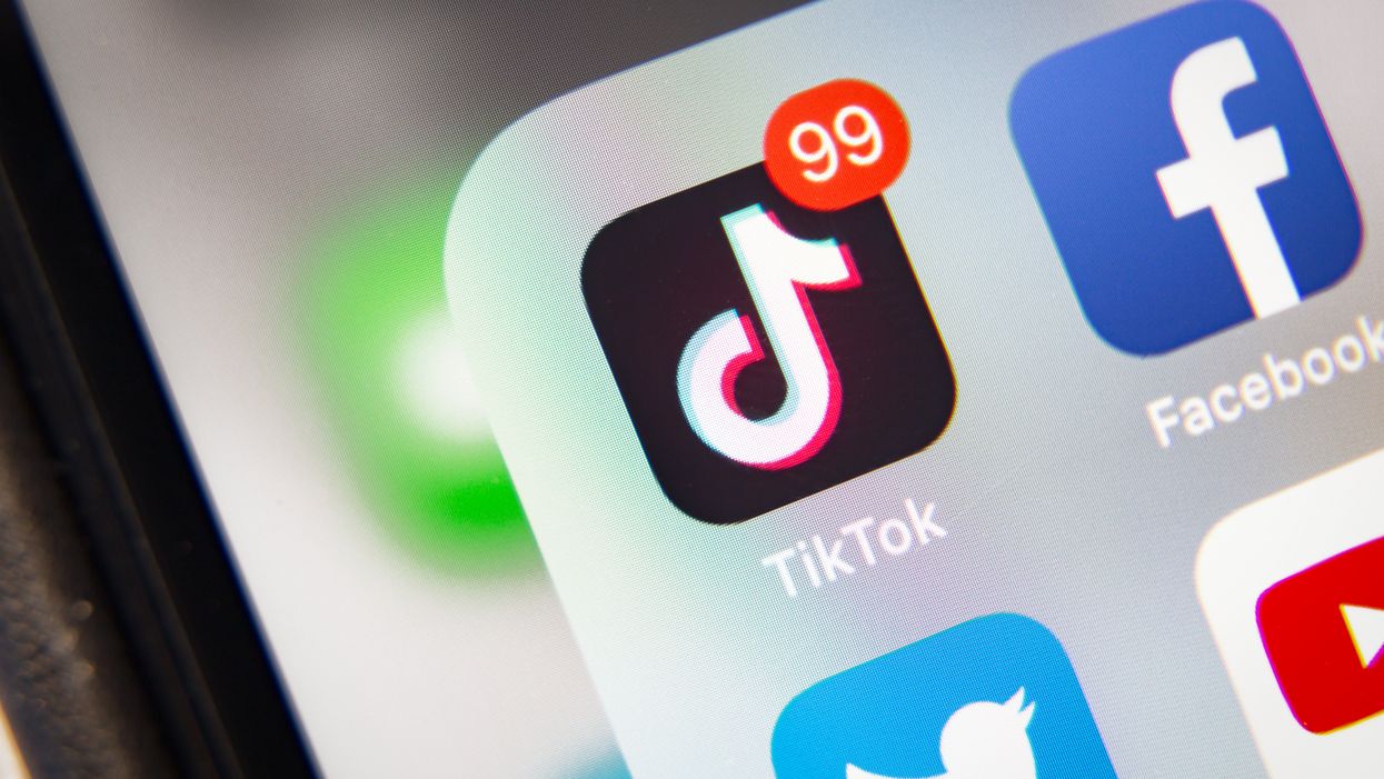 The TikTok app icon on an iPhone, with 99 notifications in the top right hand corner of the logo.