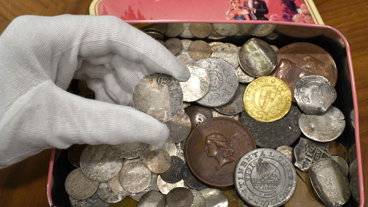 The tin of old coins (Morton & Eden/PA)