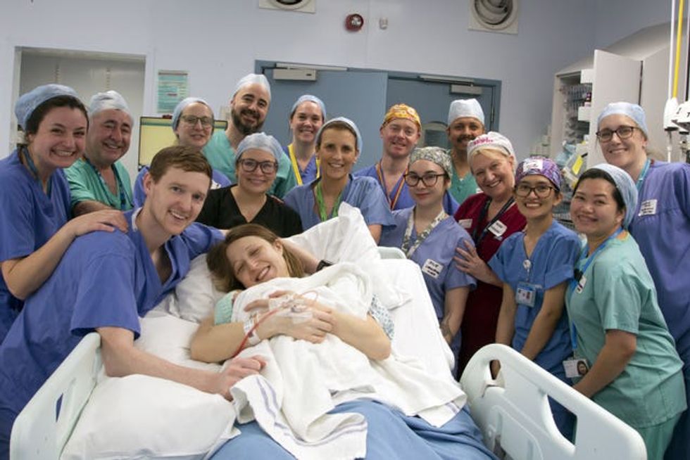 The transplant and delivery team surround the Davidsons after Amy's birth