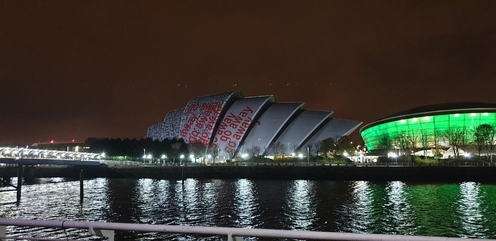 The \u2018go away\u2019 projections on the Cop26 conference centre (Graeme Eddolls/PA)