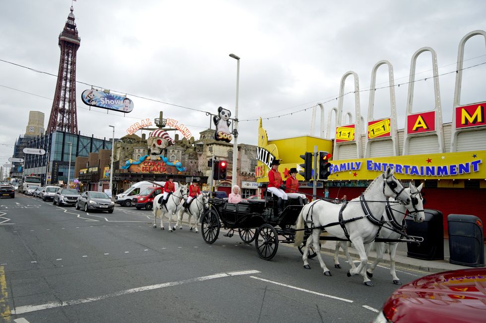 The wax figure of the Queen is driven along Blackpool\u2019s seafront in a horse-drawn carriage (Peter Byrne/PA)