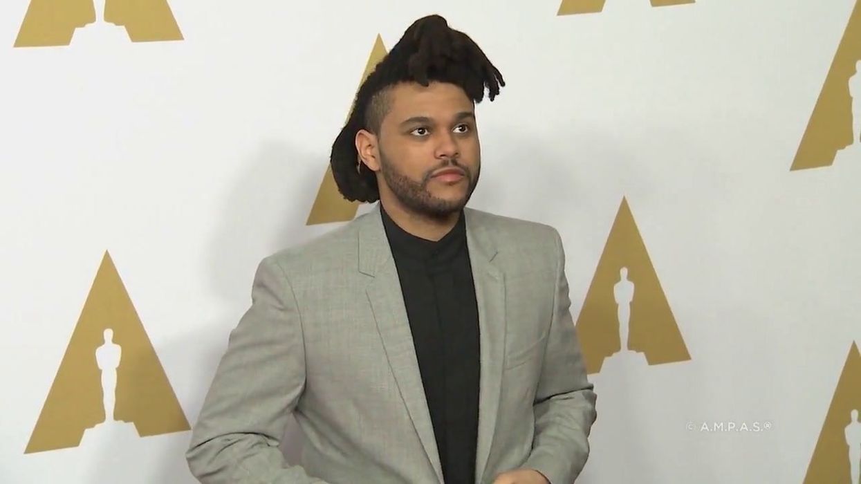 Irate The Weeknd fan grabs sign from someone blocking their view at concert