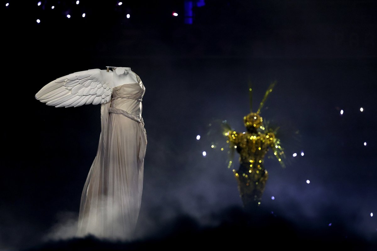 The Winged Victory of Samothrace, depicting the Greek goddess of victory (Niké) at the Paris 2024 Olympics closing ceremony, alongside the 'golden voyager'.