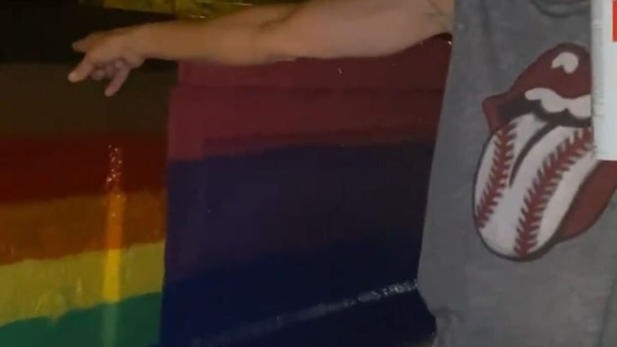 <p>The woman covered up their flag with spray paint</p>