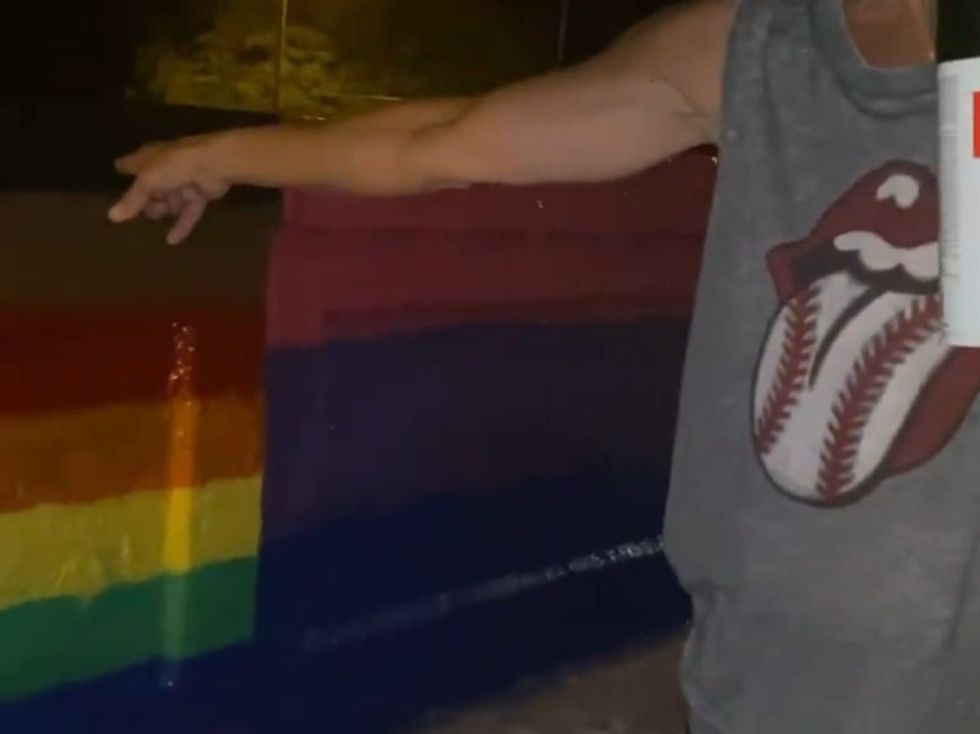 <p>The woman covered up their flag with spray paint</p>