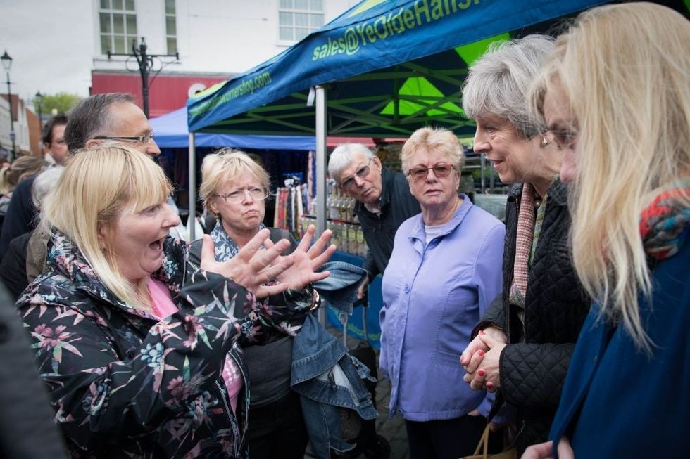 Theresa May and Cathy Mohan at Abingdon market in Oxfordshire, 15 May.