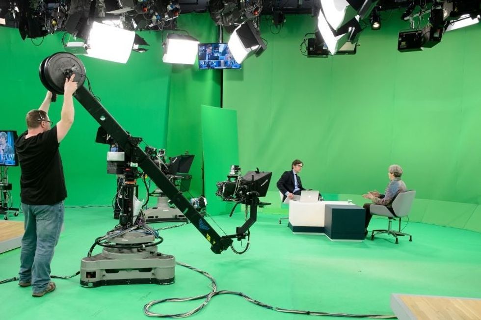 Theresa May with ITV News Political Editor Robert Peston taking part in the Facebook Live broadcast, hosted by ITV News.