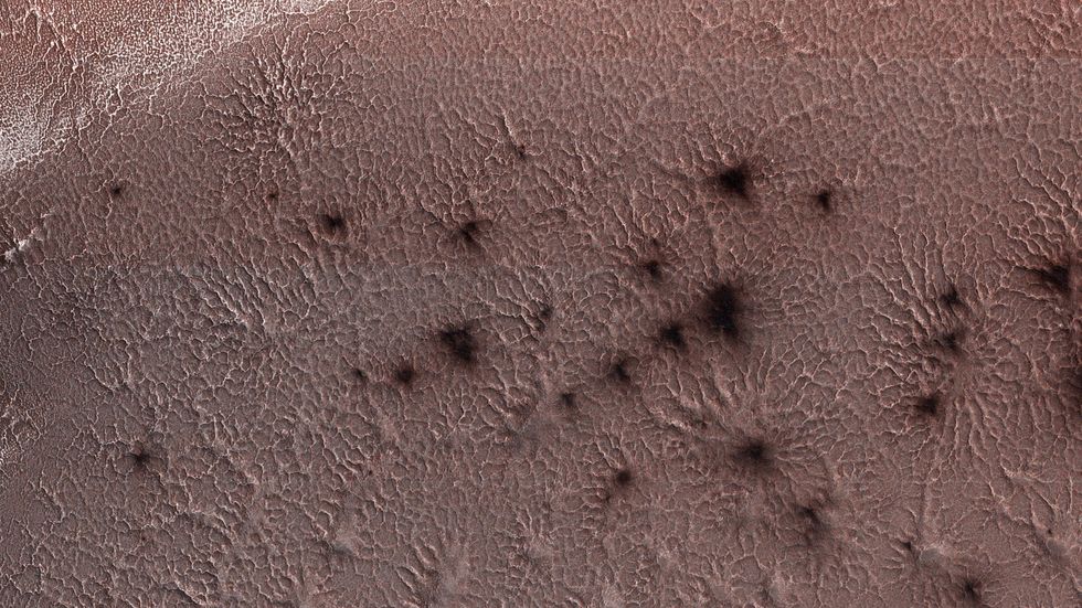 These dark 'splotches' are believed to be soil ejected from the surface by carbon dioxide gas plumes
