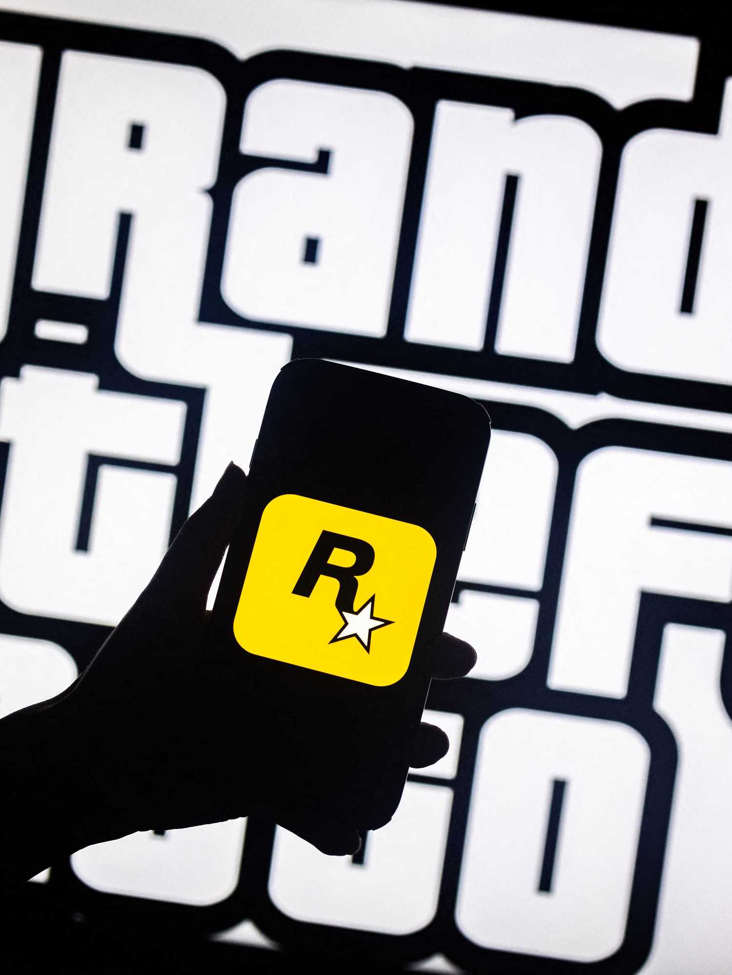 This illusttation shows a logo of Rockstar Games on a smartphone screen and a logo of a video game series Grand Theft Auto (GTA) on a TV screen in New York, November 27, 2023
