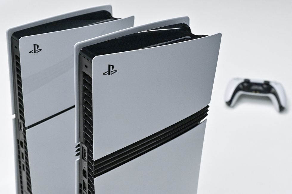 This photo illustration shows a Sony PlayStation 5 (L) and 5 Pro (C) on display at the Sony headquarters building in central Tokyo on November 27, 2024