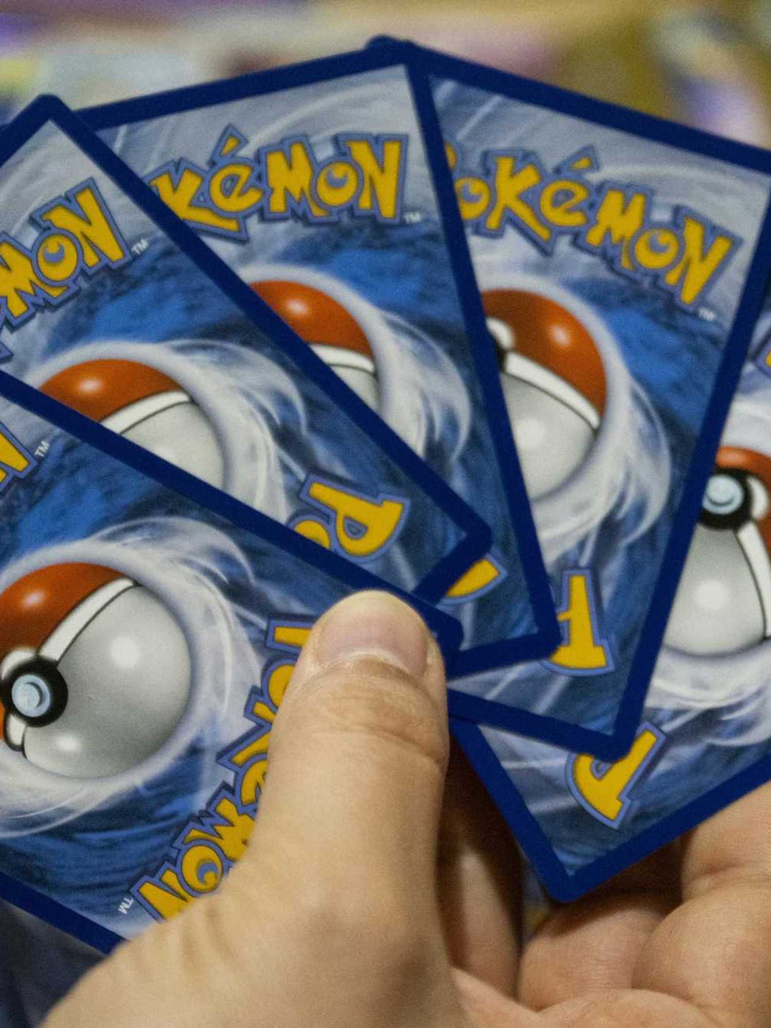 This photograph shows displayed collectible cards from the Pokemon Trading Card Game (TCG) at an amateur collector's appartment in Paris on March 11, 2026