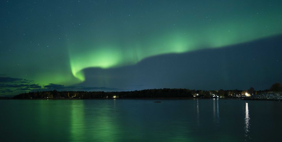This photograph shows Northern lights (Aurora Borealis) illuminating the sky above North of Vaasa, western Finland, on October 11, 2024