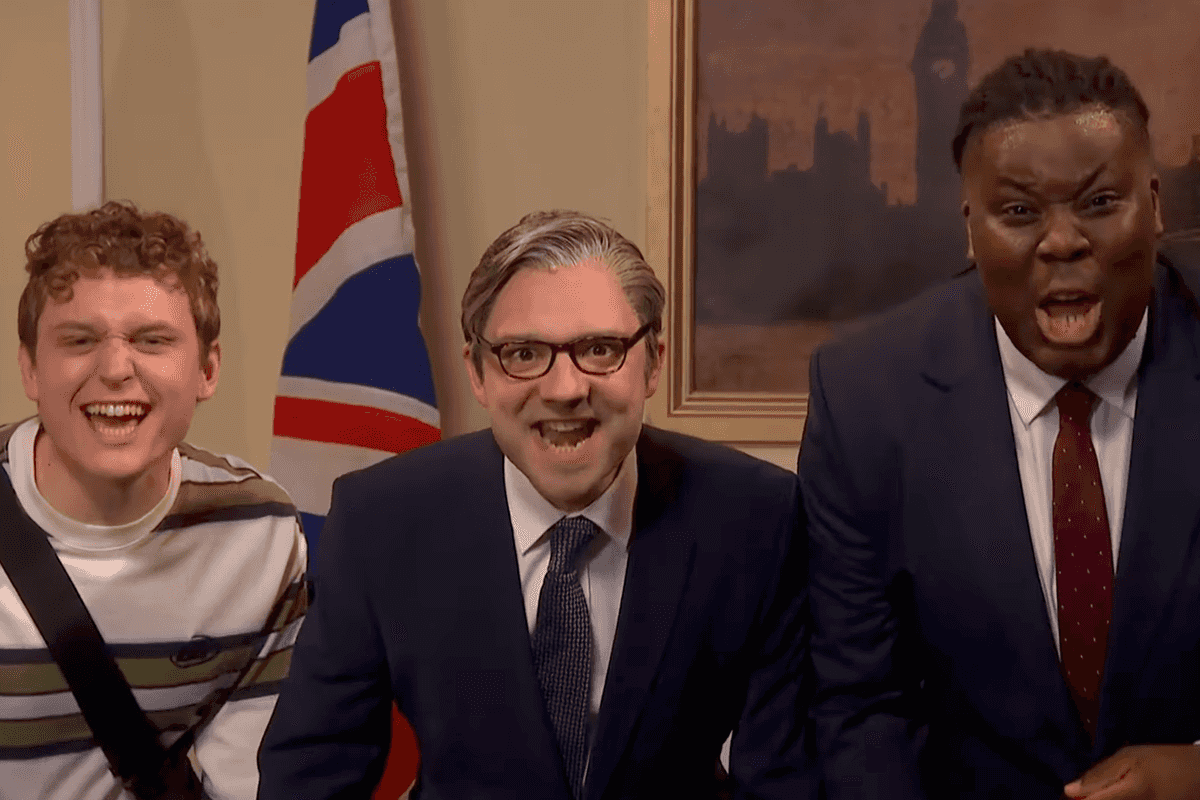 Three male actors from Saturday Night Live UK smile and shout at the camera.
