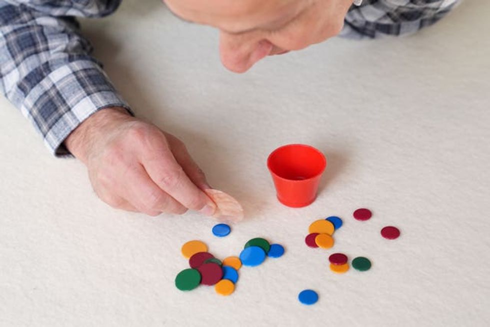 Tiddlywinks players in battle