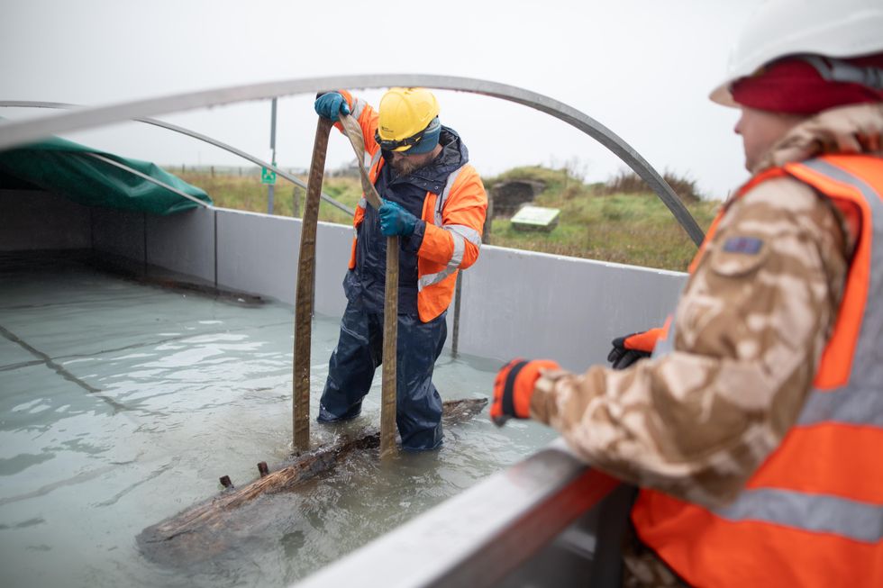 Timbers from the Sanday Wreck being placed in a fresh water tank for preservation