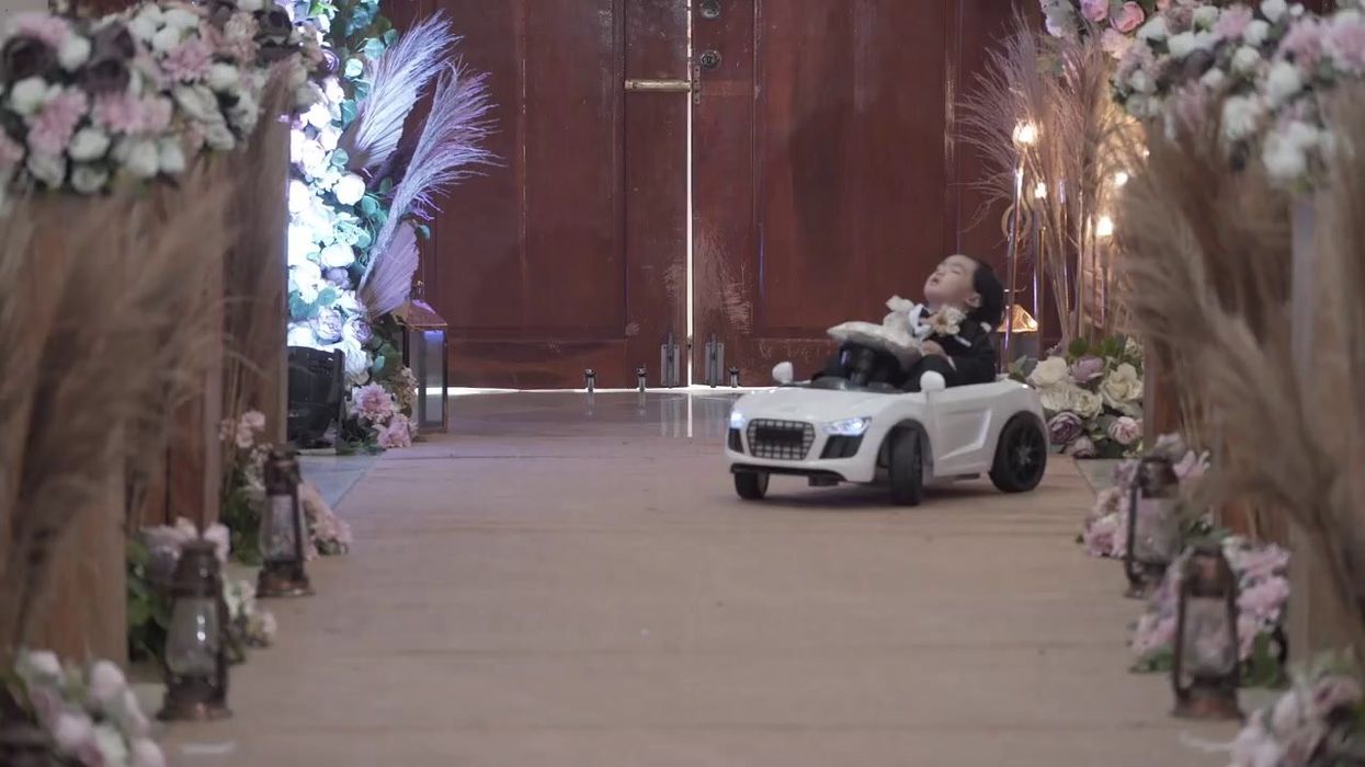 Toddler chosen as wedding ring bearer falls asleep while riding toy car down the aisle