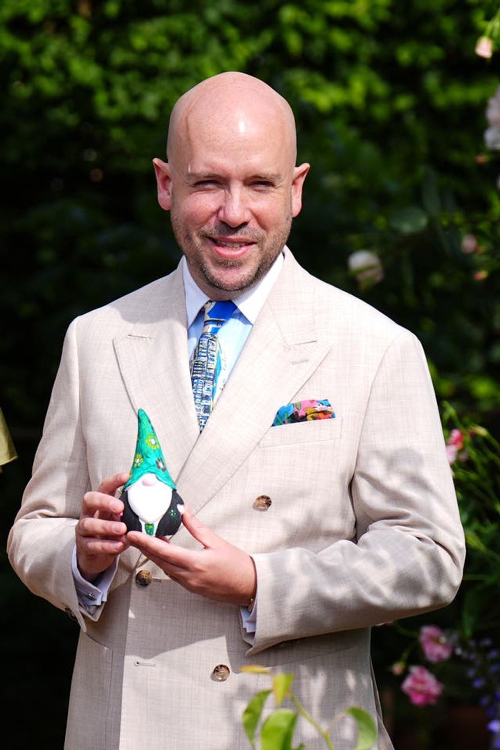 Tom Allen holding the gnome he painted to raise money for the RHS Campaign for School Gardening, at the RHS and The King\u2019s Foundation Curious Garden exhibit, during press day at the RHS Chelsea Flower Show, at the Royal Hospital Chelsea in London
