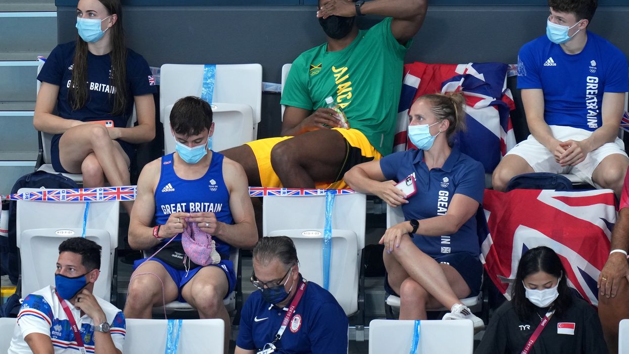 Tom Daley knits in the stands (Joe Giddens/PA)