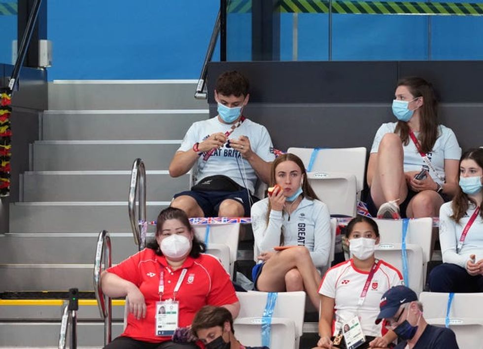 Tom Daley knitting in the stands during the Tokyo Olympics three years ago