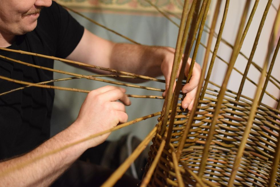 Tom Delaney at work weaving a basket