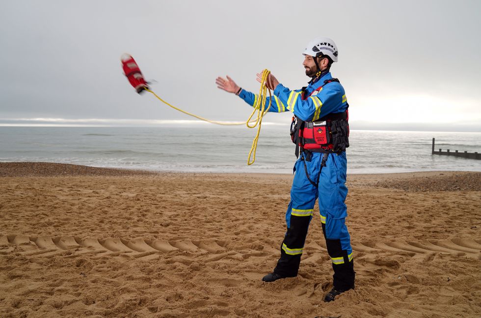 Tom Wright casts a throwline \u2013 part of the standard lifesaving kit \u2013 to mark the anniversary (Andrew Matthews/PA)