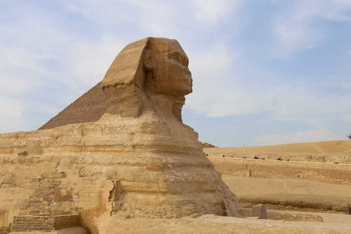 Tourists ride camels near the Sphinx and the Pyramid of Khafre or Chephren, a UNESCO World Heritage site, in Giza on the outskirts of Cairo, Egypt, on February 25, 2025