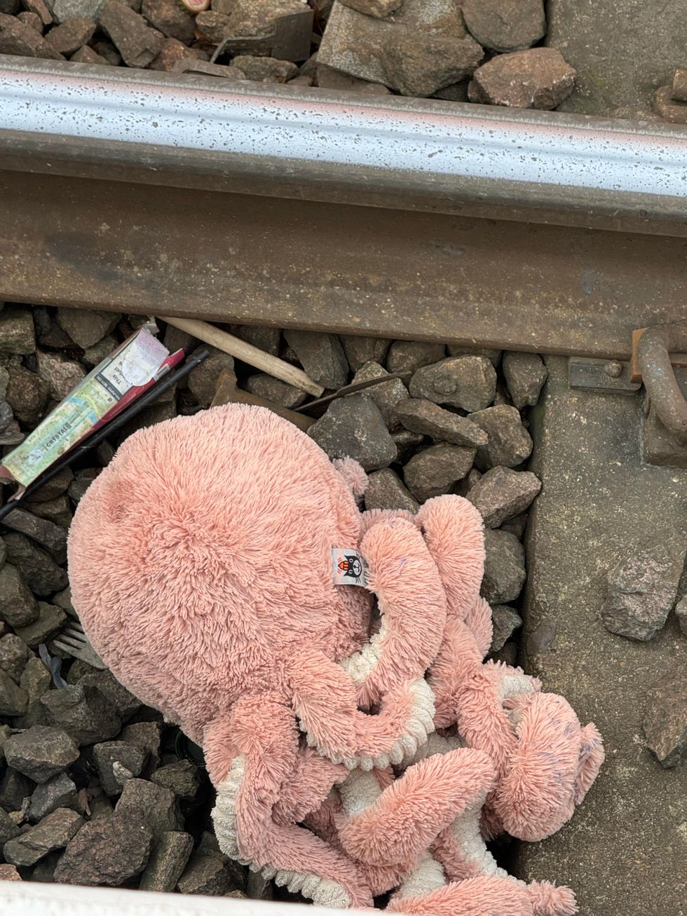 Toy octopus on train tracks