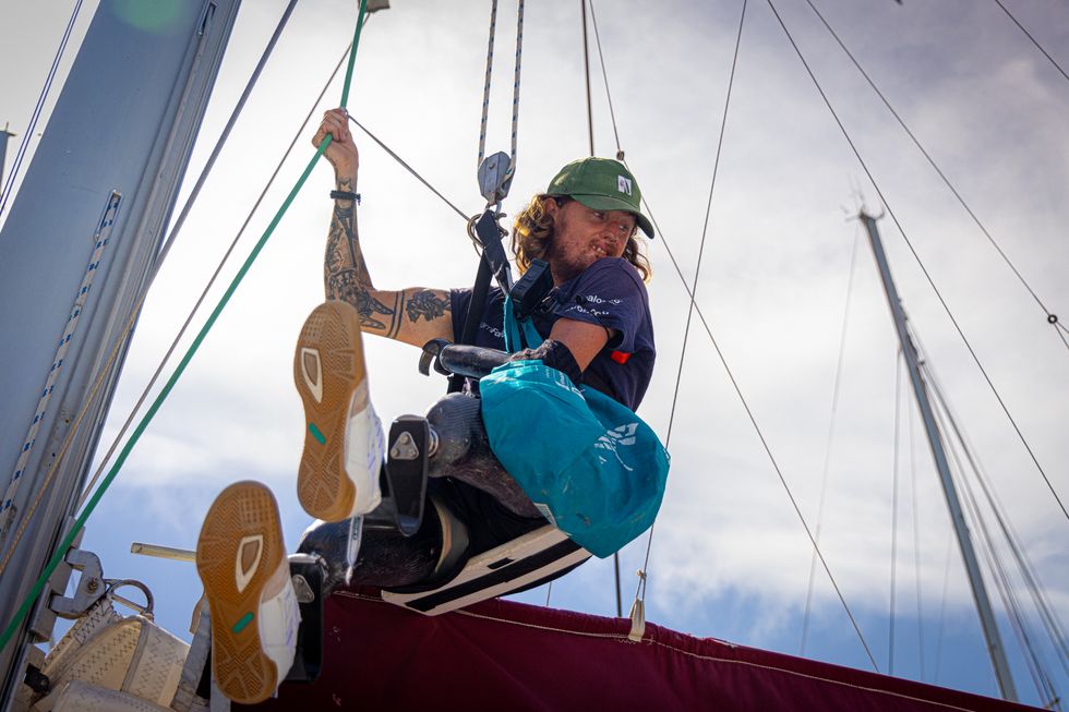 Triple amputee veteran climbing rigs on a sail boat ahead of his voyage across the Pacific Ocean
