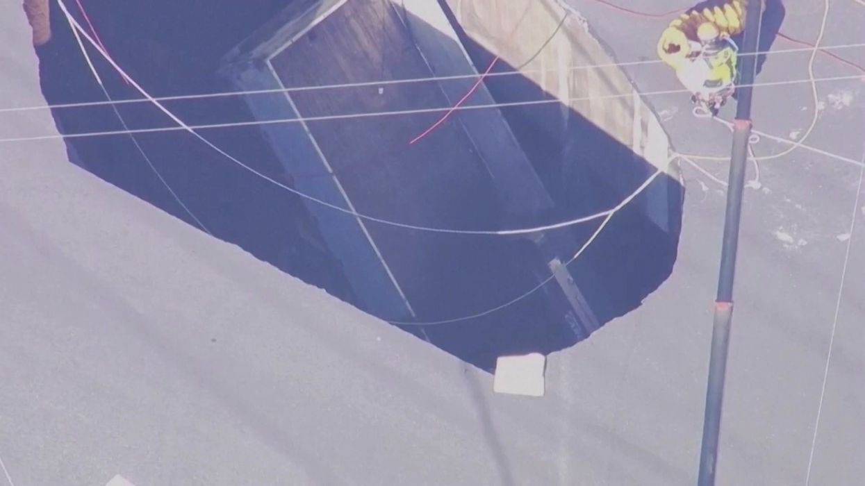 Driver stuck inside sinkhole for more than 48 hours after pool-sized hole tears up road