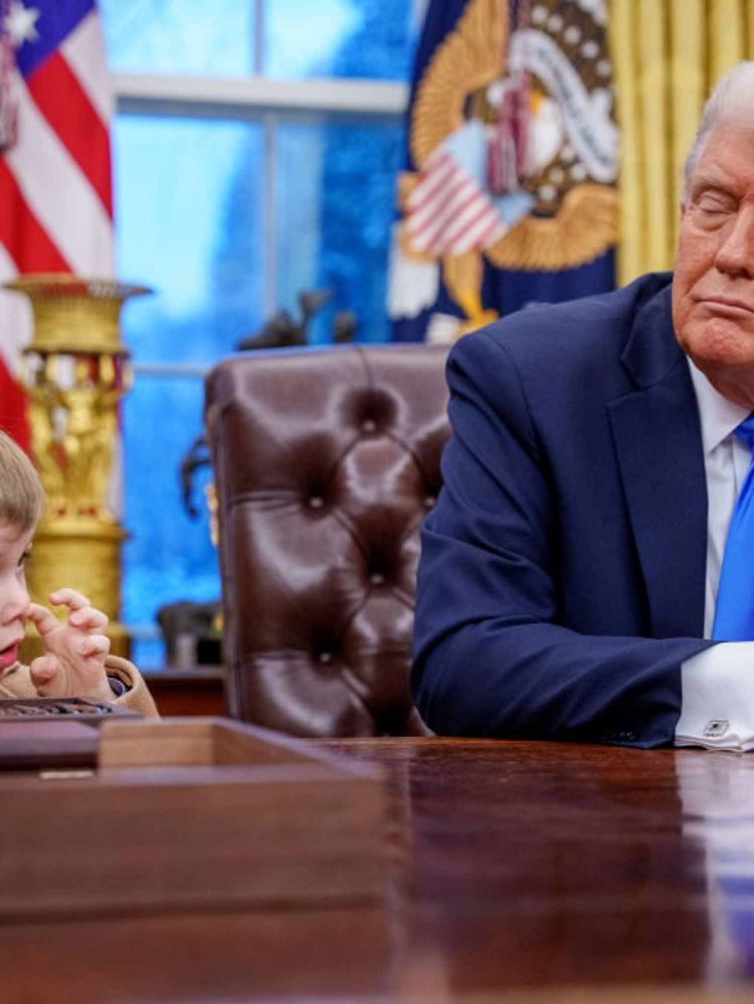 Donald Trump 'babysitting' Elon Musk's son in the Oval Office becomes an instant meme