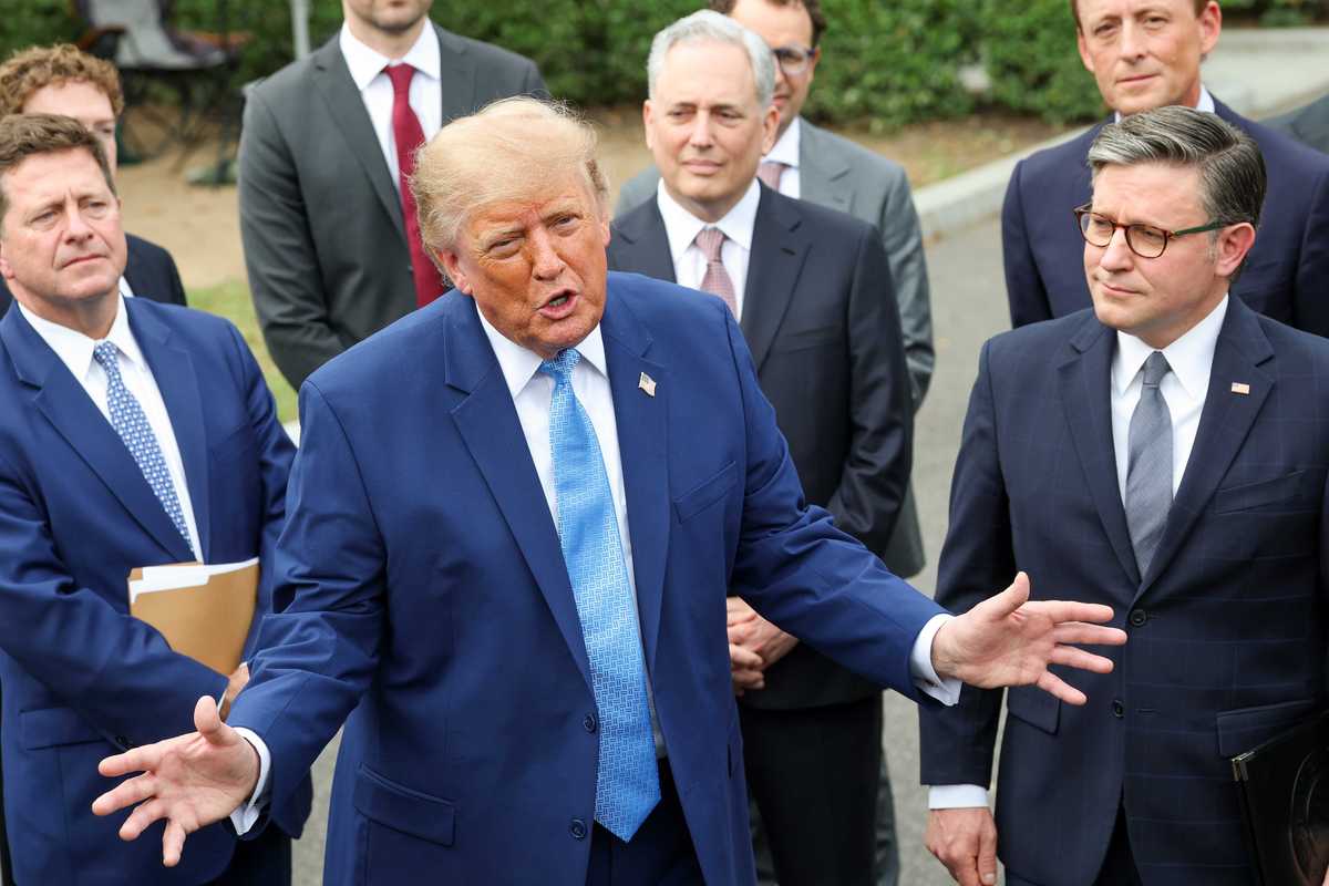 Trump speaks to reporters outside the White House while surrounded by tech CEOs.
