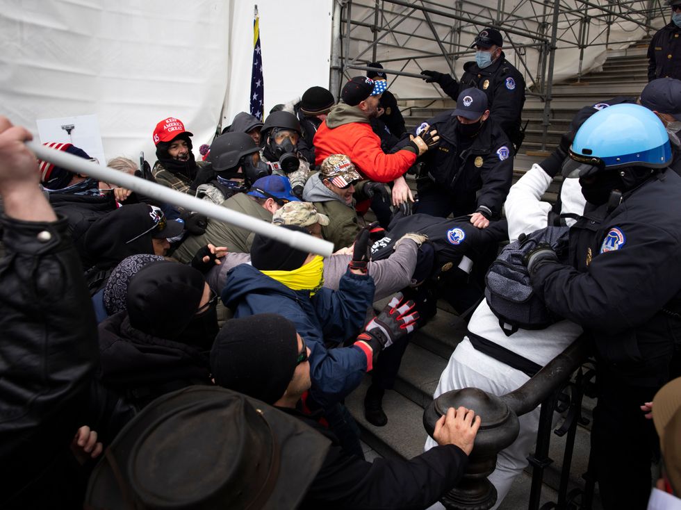 Trump Supporters Hold "Stop The Steal" Rally In DC Amid Ratification Of Presidential Election WASHINGTON, DC - JANUARY 06: Trump supporters clash with police and security forces as people try to storm the US Capitol in Washington D.C on January 6, 2021. Demonstrators breeched security and entered the Capitol as Congress debated the 2020 presidential election Electoral Vote Certification. (photo by Brent Stirton/Getty Images)