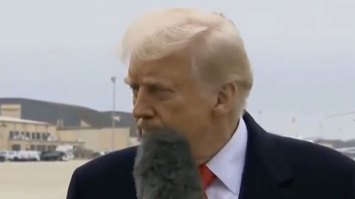 Moment Donald Trump gets hit in the face by reporter's microphone