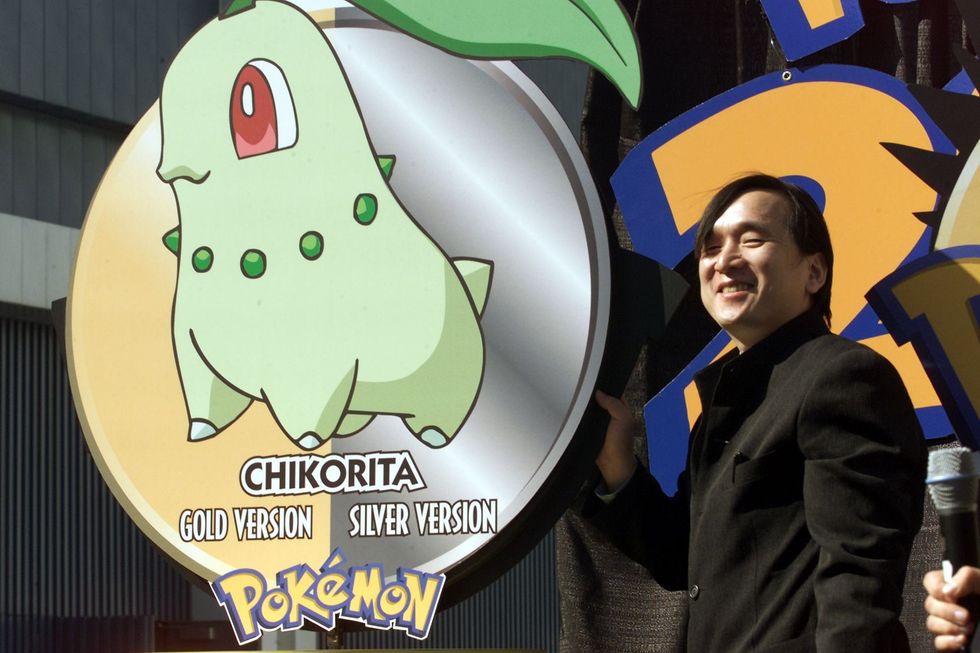 Tsunekazu Ishihara (L) co-creator of Pokemon Universe introduces a new character called Chikorita at the Los Angeles Convention Center 09 May, 2000