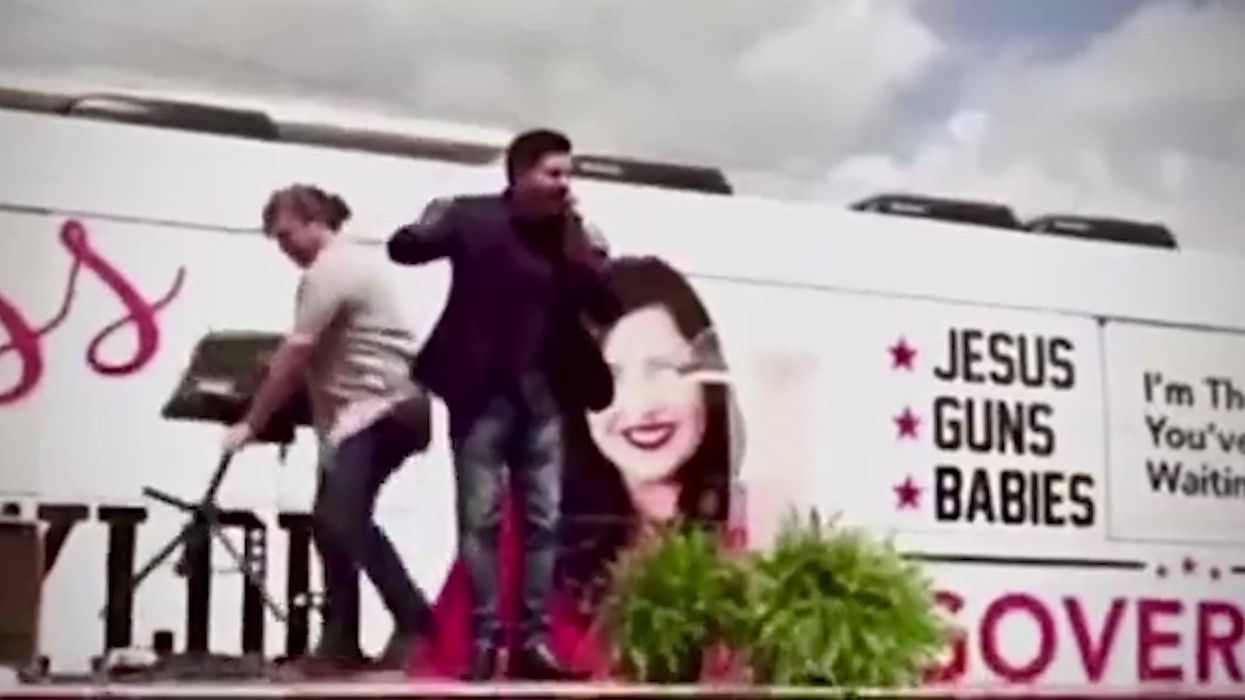 TV falls on political activist as he brands democrats 'demonic' at rally