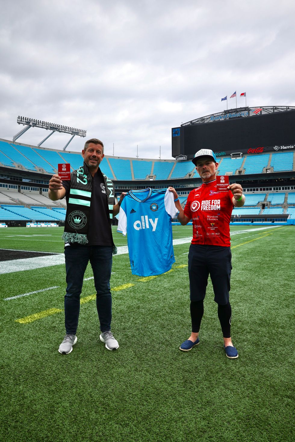 Two men holding a t-shirt
