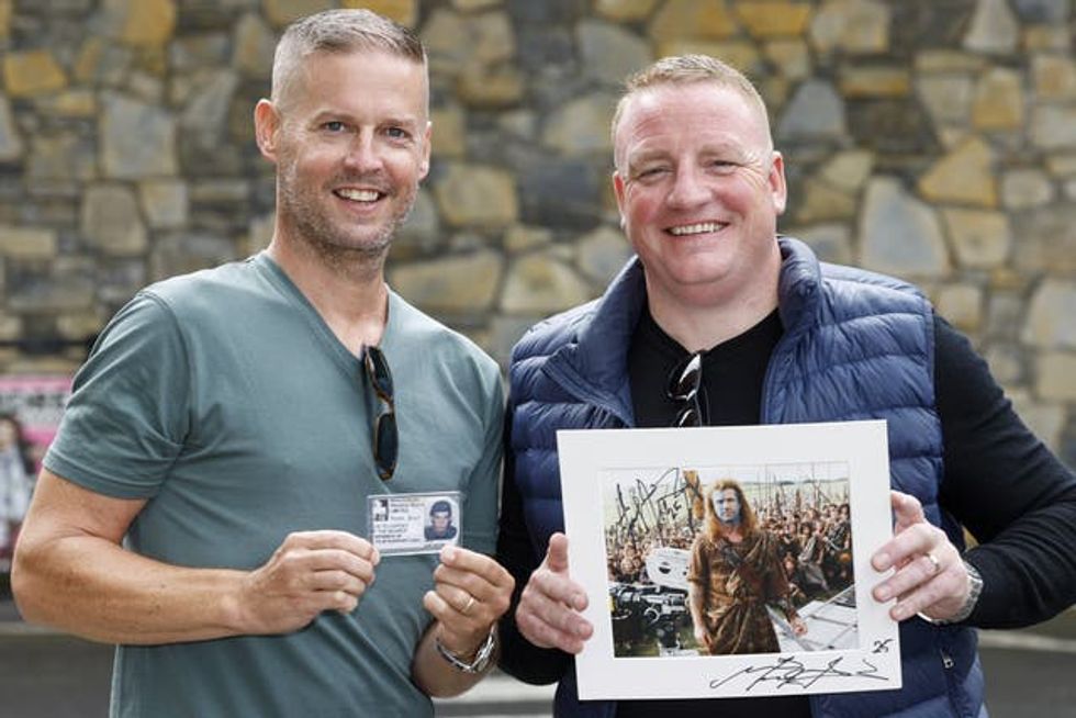 Two men holding film memorabilia
