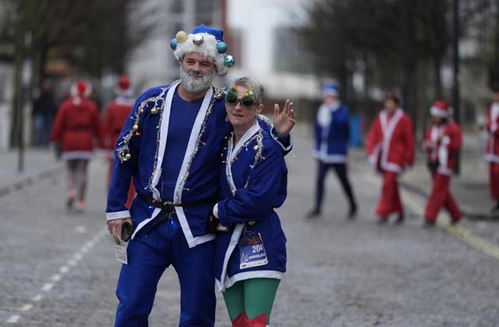 Two participants dressed in blue Santa suits