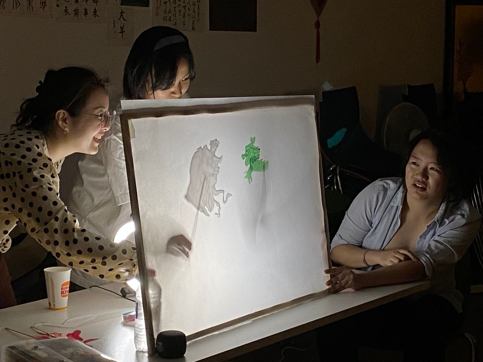 Two people creating a marionette