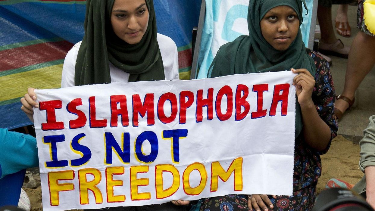 Two women hold a sign at an anti-Islamophobia protest